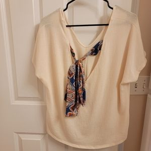 Light cream top with knot bottom front and colorful tie back